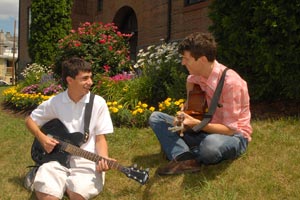 Christopher Rizzo (left) and Michael Quinn practice guitars. Photo courtesy of <a href=