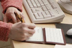 A woman writing a check
