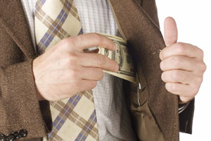 A man inserting money into his coat pocket