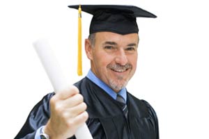 A man in a cap and gown holding a diploma
