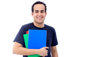 A male college student holding notebooks