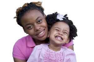 A mother and daughter smiling