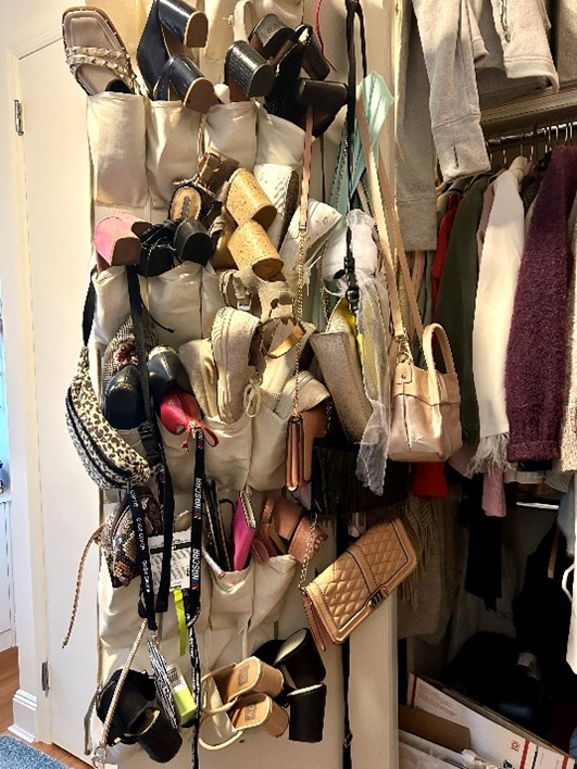 A shoe rack hanged in a door full of shoes