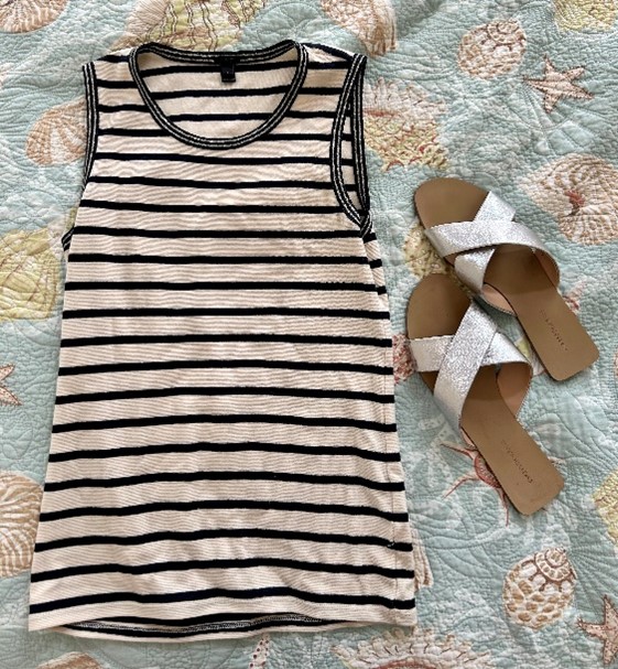 A striped blue and white tank top and a metallic flat.