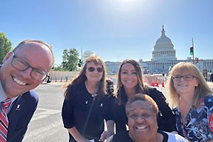 A group standing in front of the Capitol in Washington, D.C.