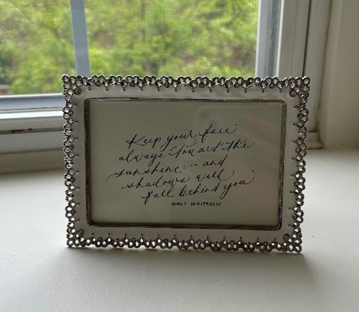 A picture frame with a handwritten note.