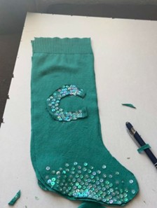 A picture of a teal stocking with the letter C 