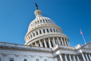U.S. Capitol dome against a bright blue sky