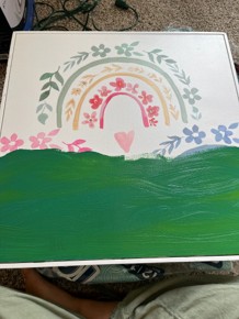 Canva with flowers on top and green paint in the bottom