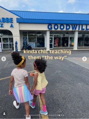 Two girls walking in front of a Goodwill store